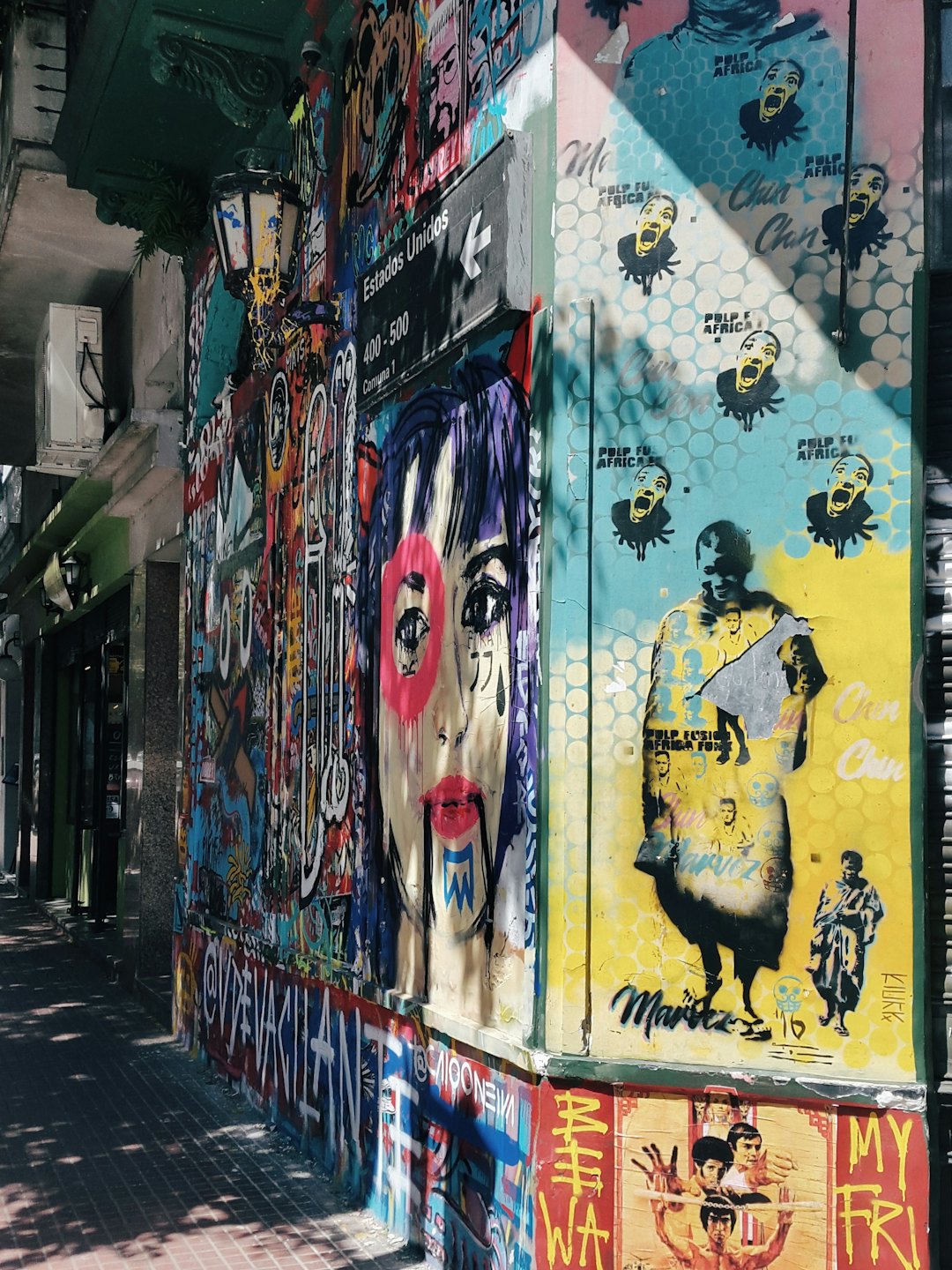 Colorful street art mural covering the walls of a corner.